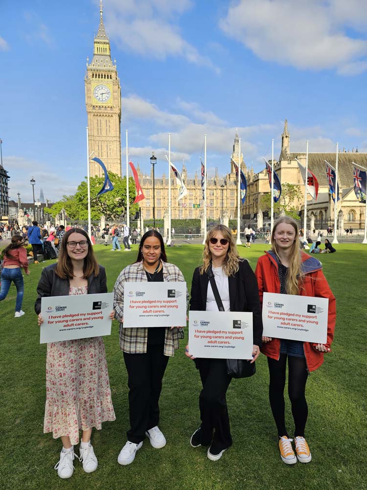 Young carers alliance pledge group outside Houses of Parliament